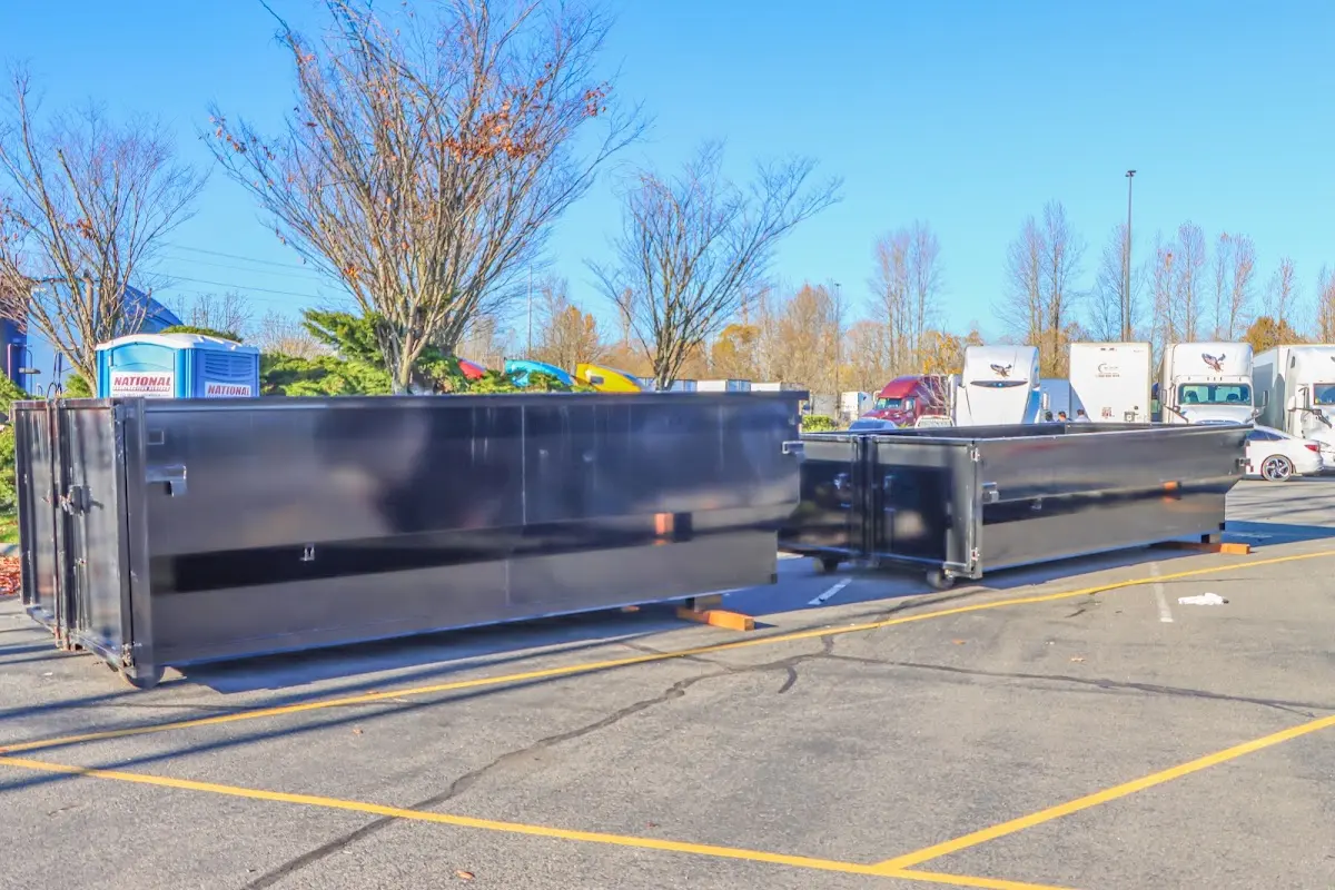Professional dumpster rental service with roll-off container on residential driveway in Chadron
